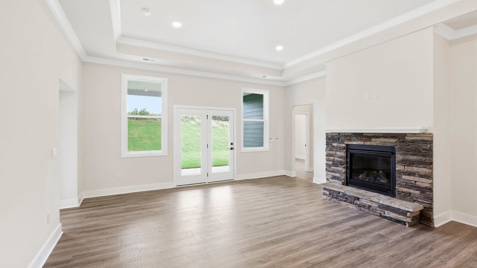 Living room with windows and fireplace.
