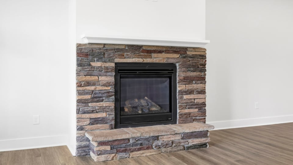 Living room with windows and fireplace.