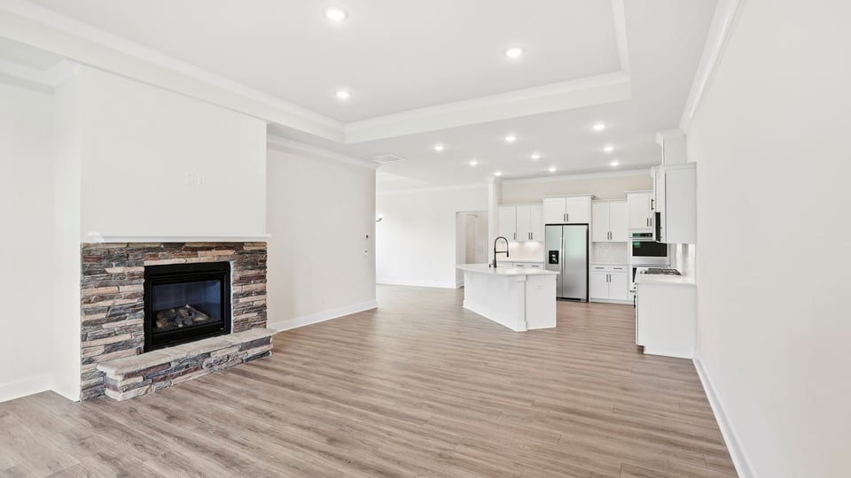 Living room with windows and fireplace.