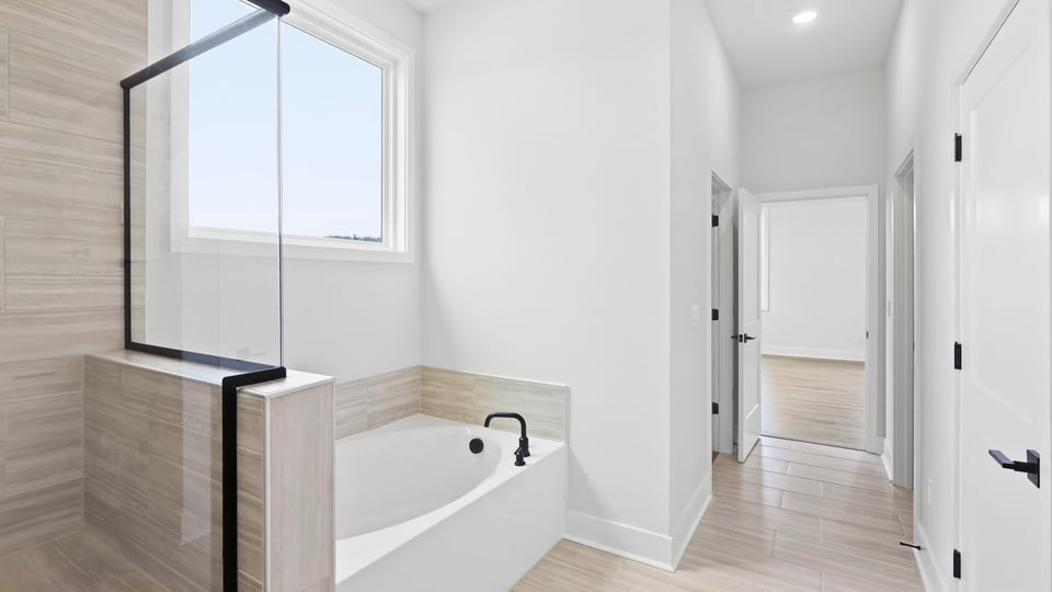 Bathroom with walk in shower and bathtub.