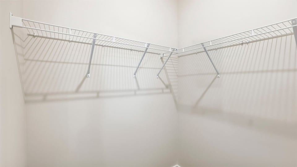 Closet with hanging storage racks.