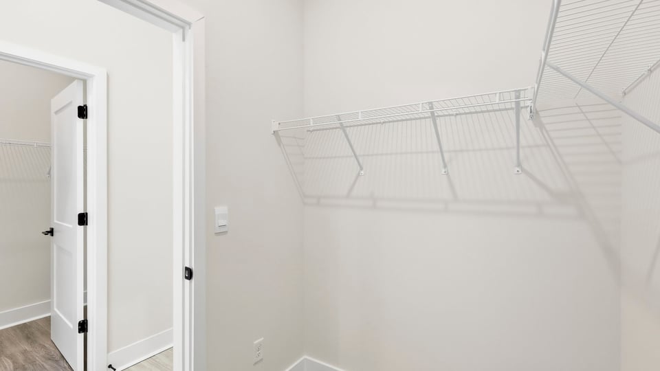 Closet with hanging storage racks.