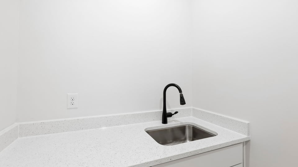 Laundry room with cabinets.