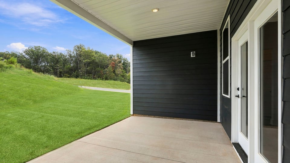 Back exterior of home with covered patio.