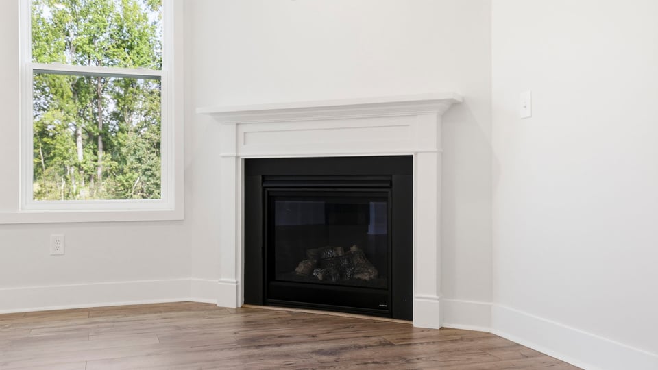 Living room with windows and fireplace.