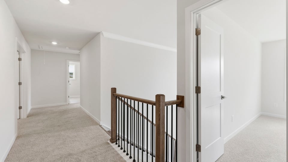 Loft area with carpet and window.