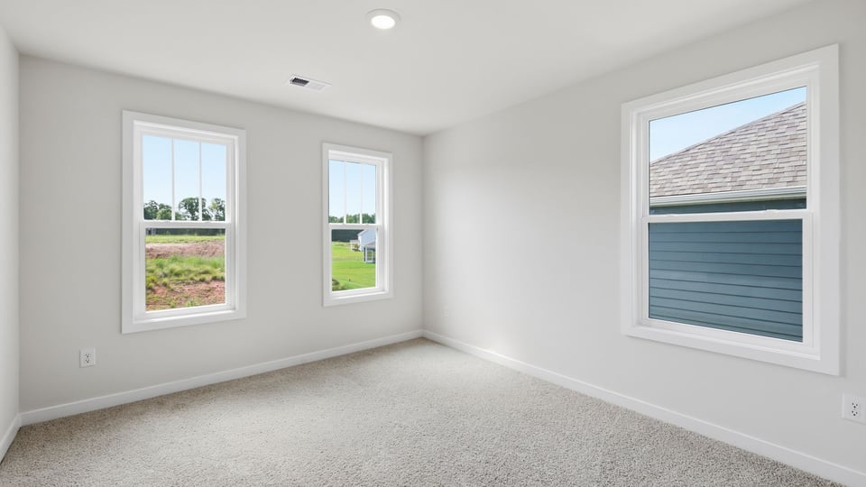 Bedroom with carpet and window.