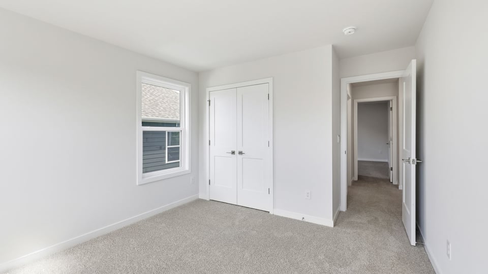 Bedroom with carpet and window.