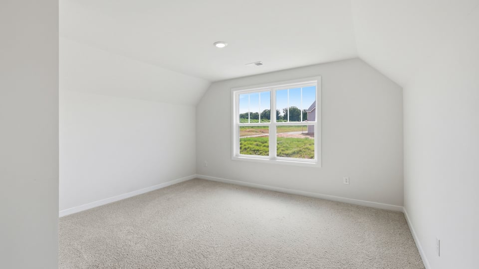 Bedroom with carpet and window.