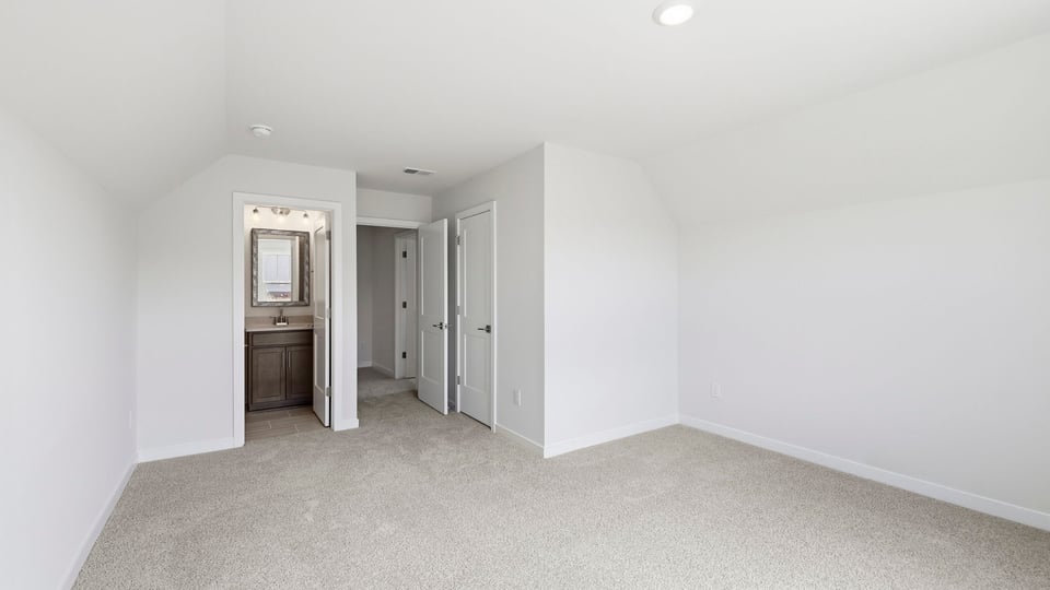 Bedroom with carpet and window.