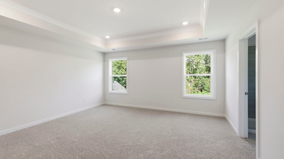 Bedroom with carpet and window.
