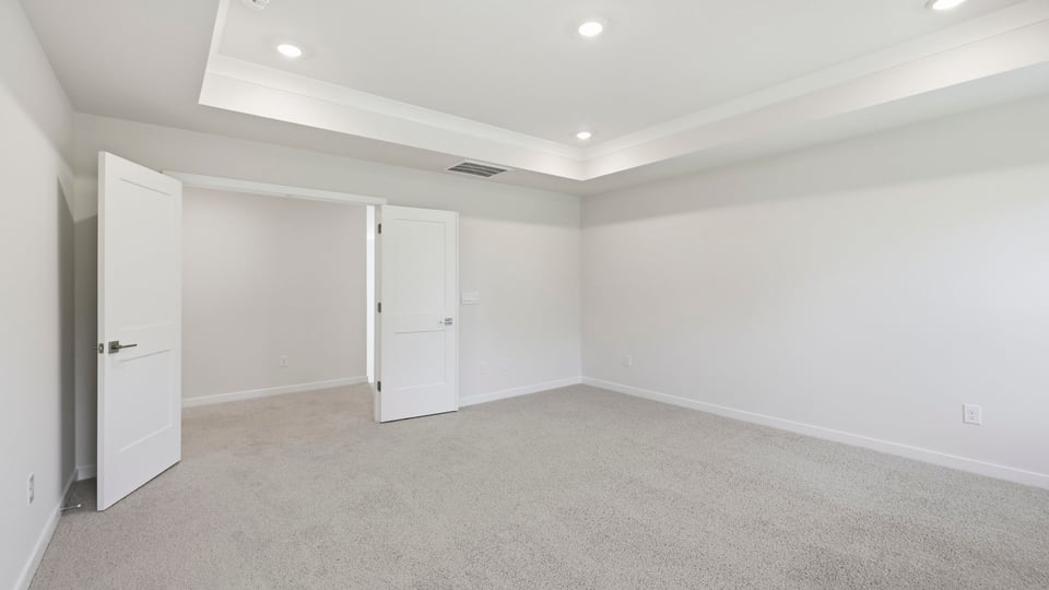 Bedroom with carpet and window.