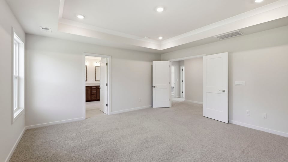 Bedroom with carpet and window.