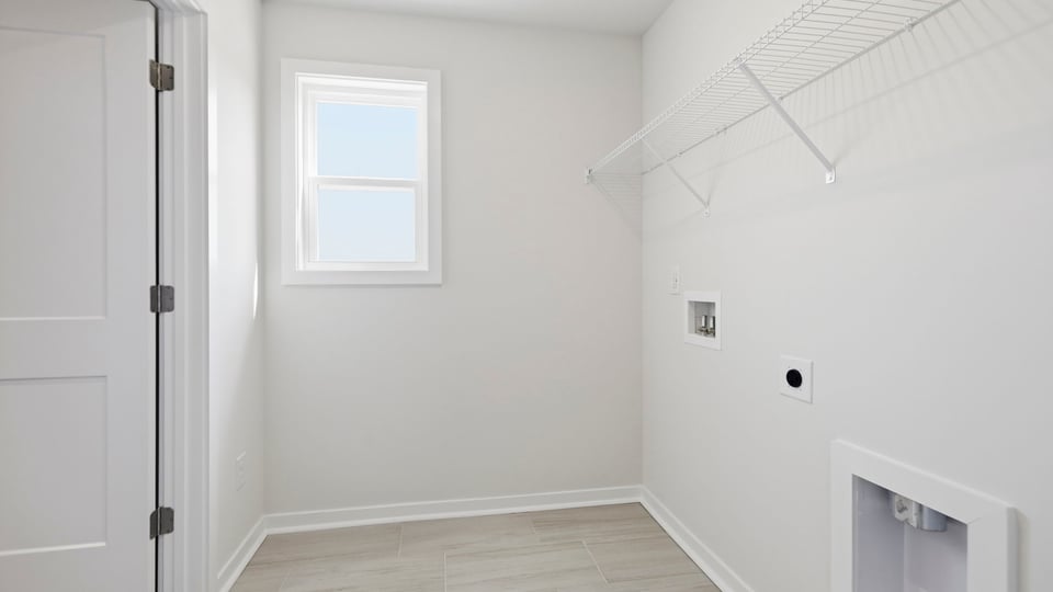Laundry room with hanging storage racks.
