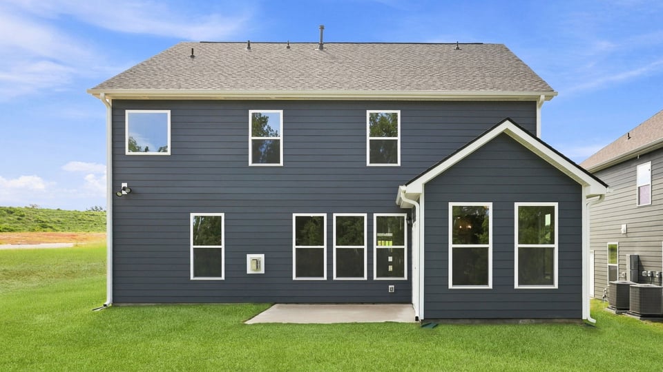Back exterior of home with large backyard.