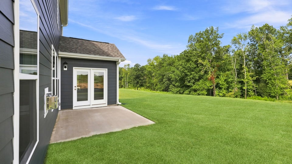 Back exterior of home with patio.