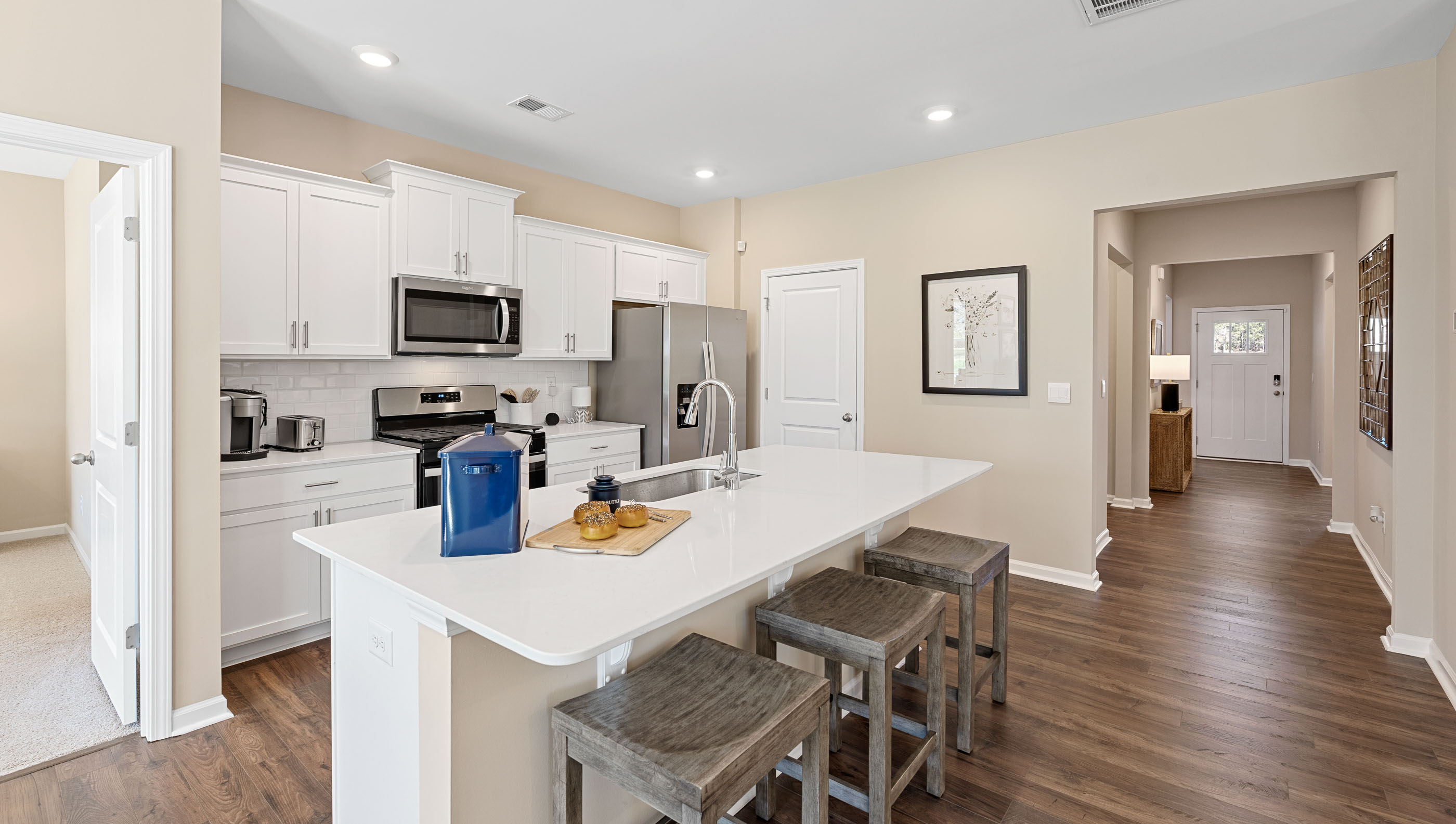 Kitchen and island with quartz countertops.