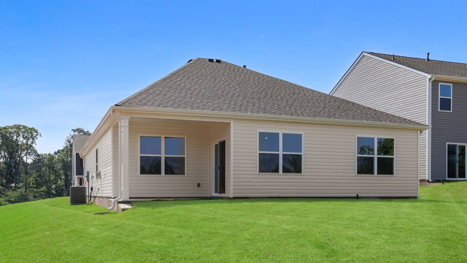 Back exterior of home with large backyard.