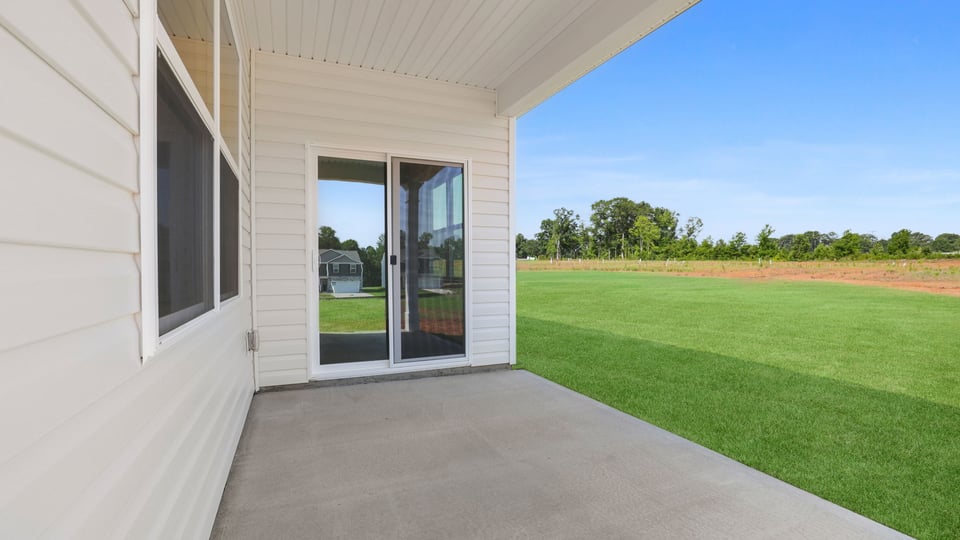 Back exterior of home with patio.