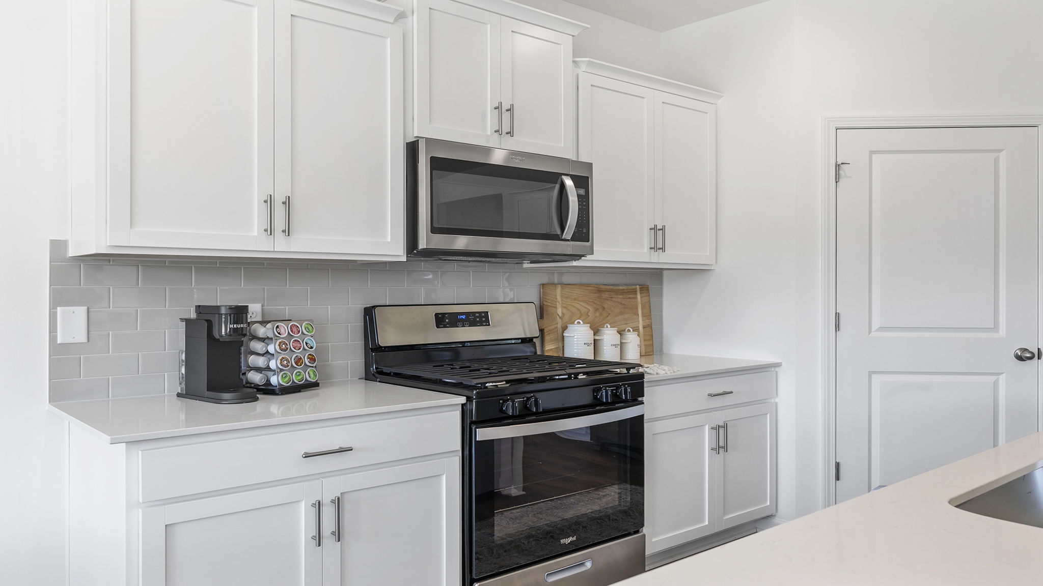 Kitchen and island with quartz countertops.