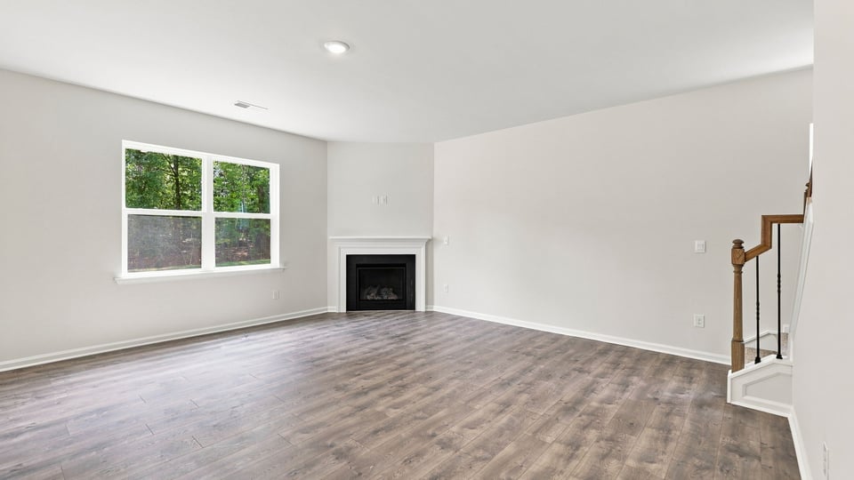 Living room with fireplace and windows.