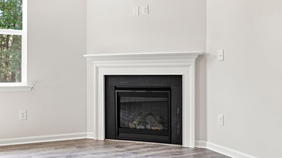 Living room with fireplace and windows.