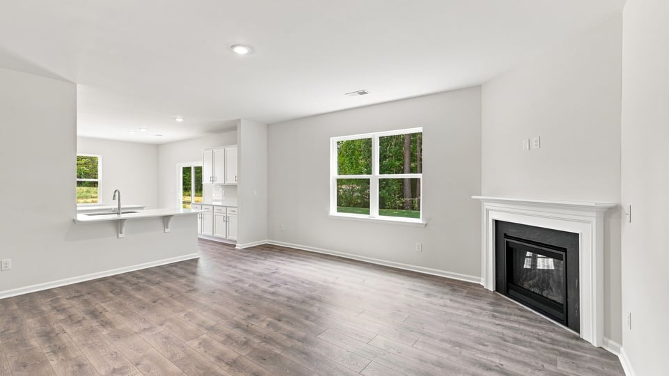 Living room with fireplace and windows.