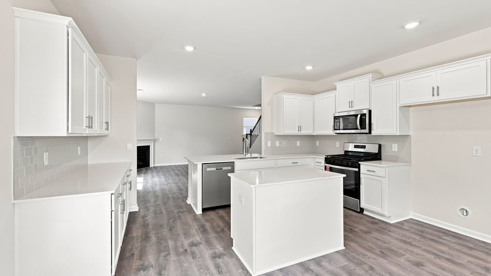 Kitchen and island with quartz countertops.