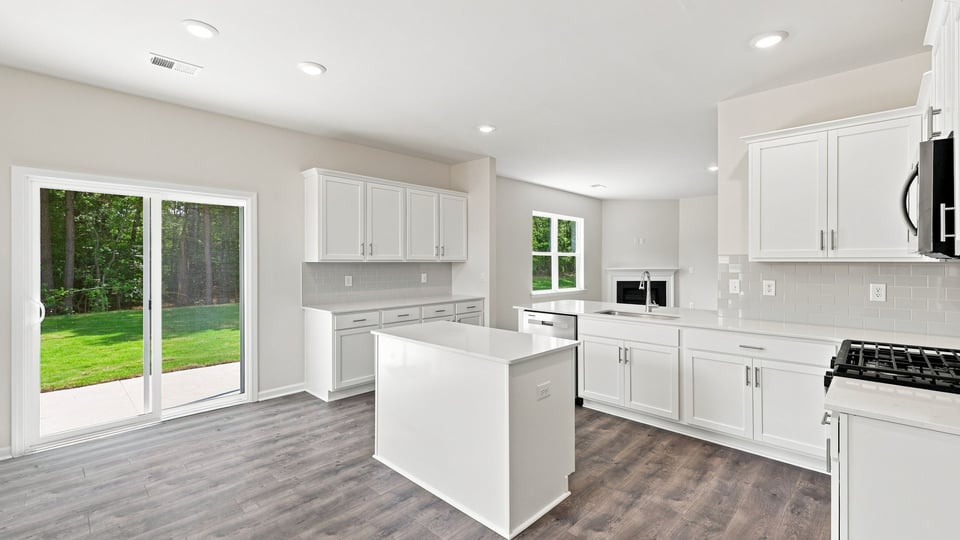 Kitchen and island with quartz countertops.