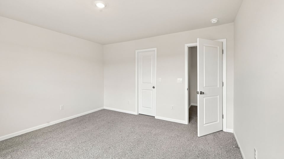 Bedroom with carpet and window.