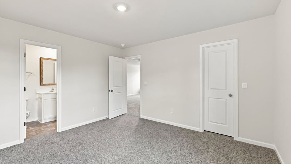 Bedroom with carpet and window.