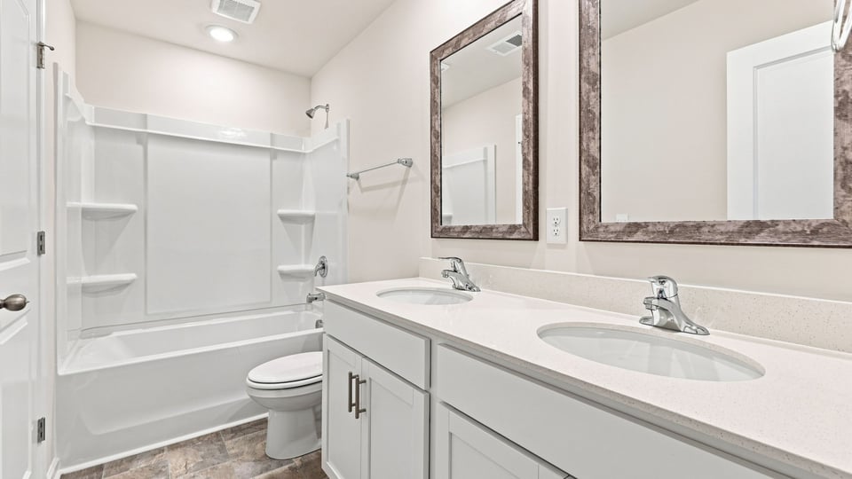 Bathroom with double vanity sink and bathtub.