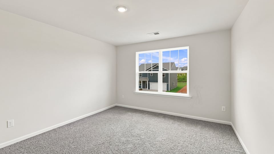 Bedroom with carpet and window.