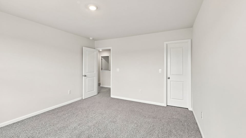 Bedroom with carpet and window.
