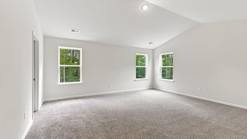 Bedroom with carpet and window.