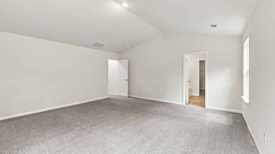 Bedroom with carpet and window.
