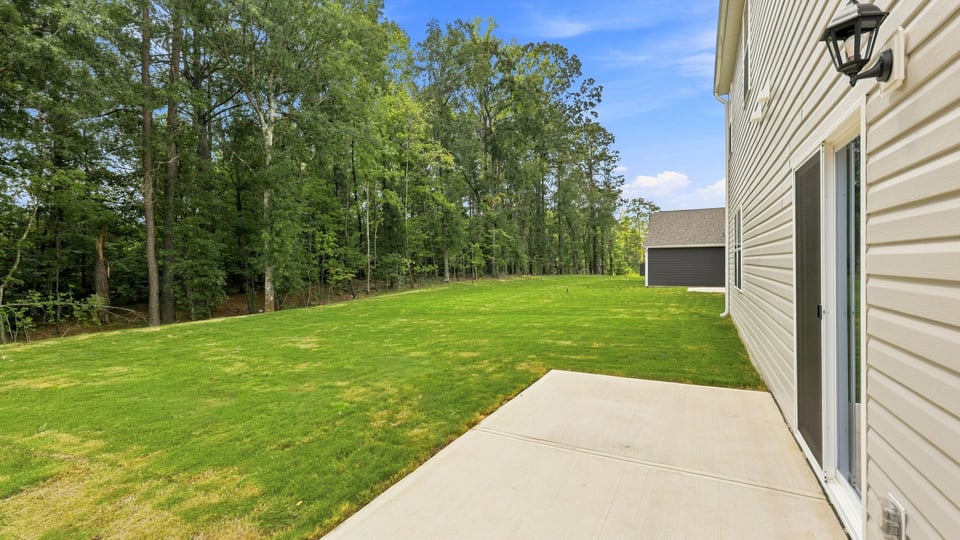 Back exterior of home with patio.