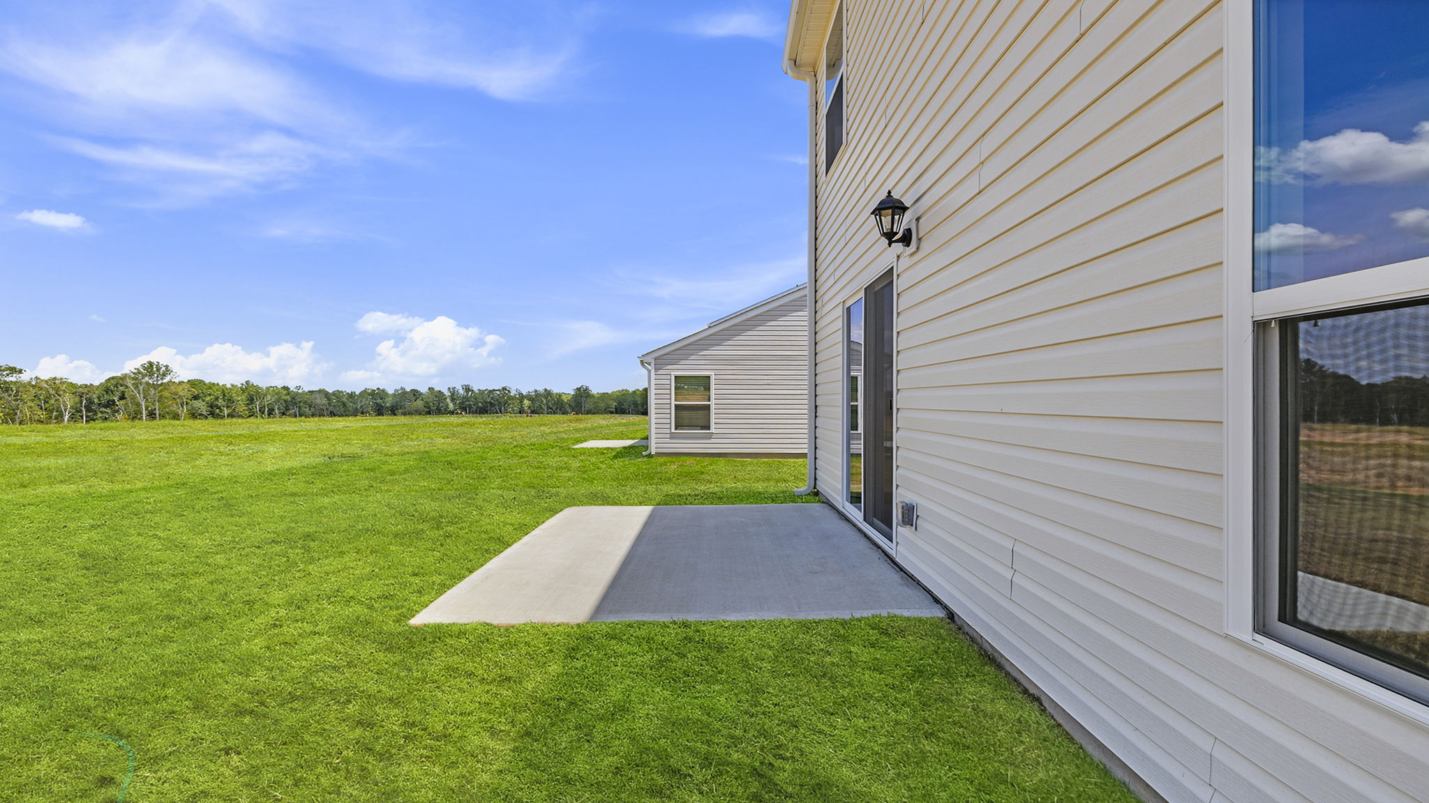 Back exterior with large backyard.