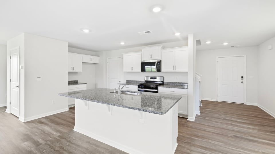 Kitchen and island with quartz countertops.