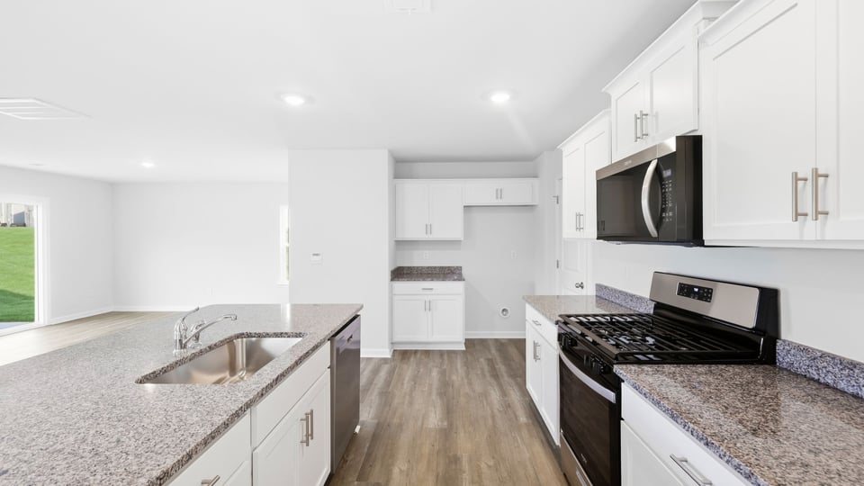 Kitchen and island with quartz countertops.