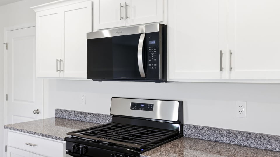 Kitchen and island with quartz countertops.