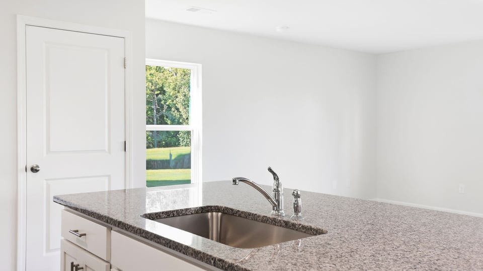 Kitchen and island with quartz countertops.