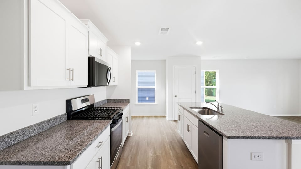 Kitchen and island with quartz countertops.
