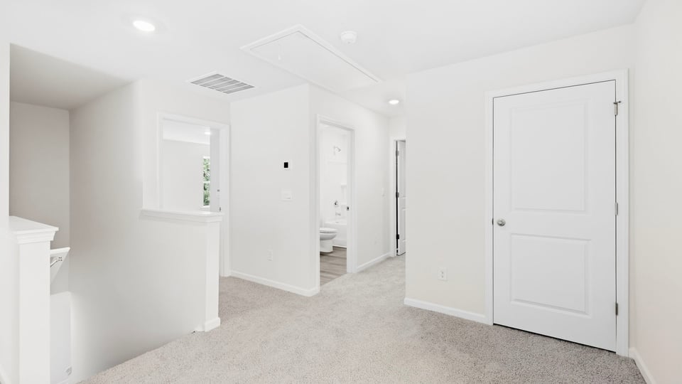 Loft area with carpet.