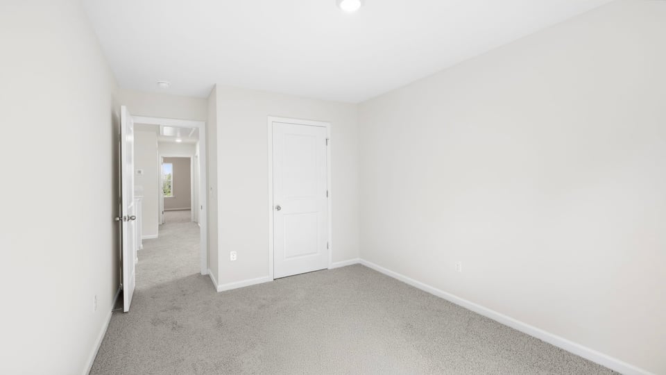 Bedroom with carpet and window.