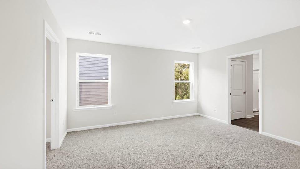 Bedroom with carpet and window.