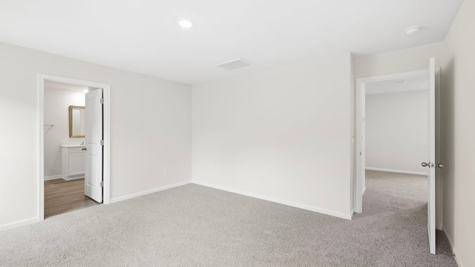 Bedroom with carpet and window.