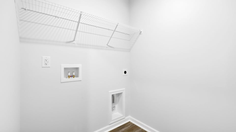 Laundry room with hanging storage racks.