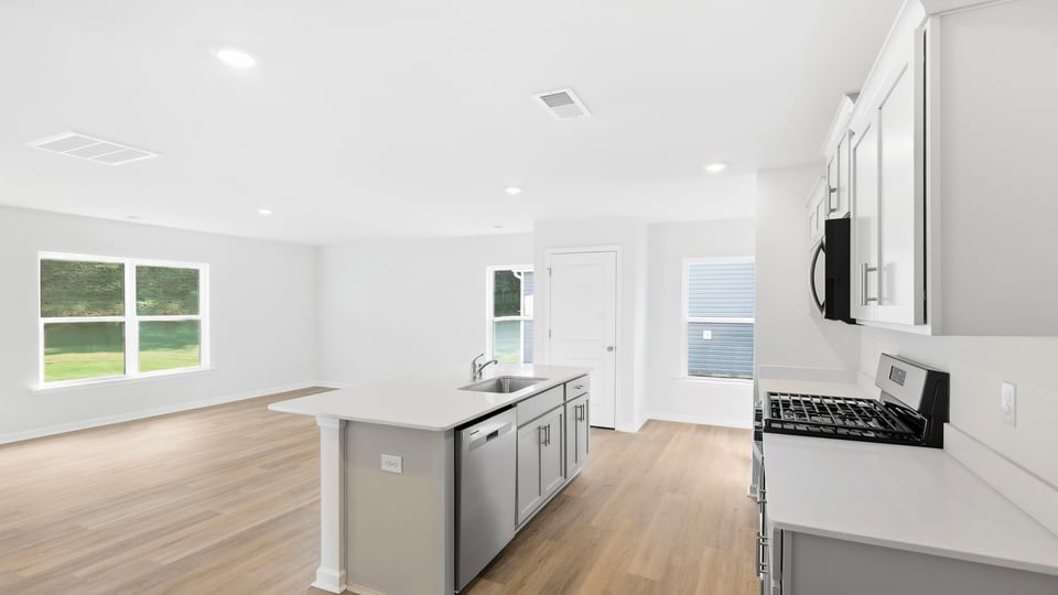 Kitchen and island with quartz countertops.