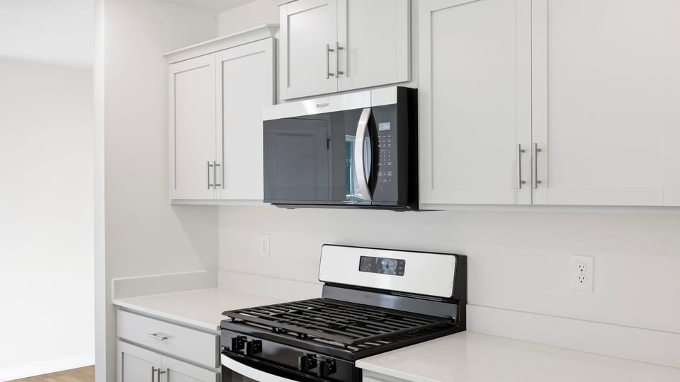 Kitchen and island with quartz countertops.